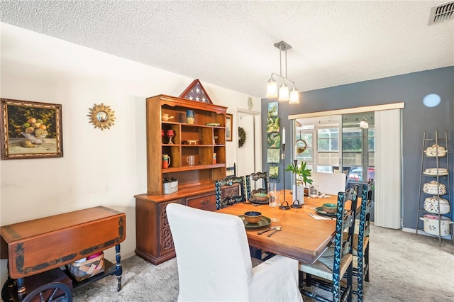 carpeted dining area with lofted ceiling, visible vents, and a textured ceiling