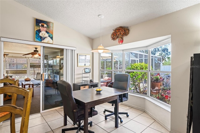 office space featuring lofted ceiling, a sunroom, light tile patterned flooring, ceiling fan, and a textured ceiling