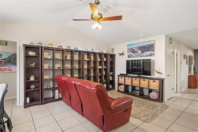 living room featuring light tile patterned floors, ceiling fan, a textured ceiling, visible vents, and vaulted ceiling