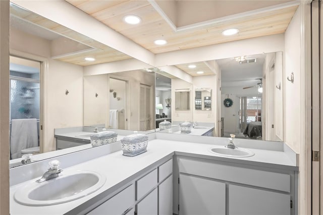 bathroom featuring recessed lighting, double vanity, a sink, and ensuite bathroom