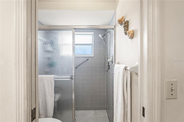 full bathroom with a stall shower and toilet