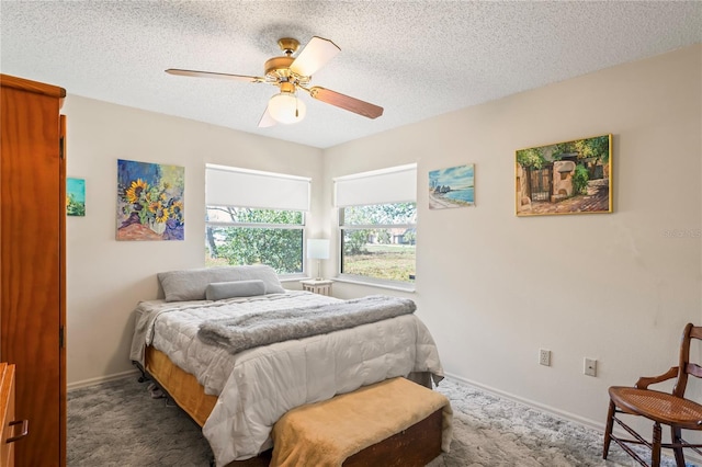 carpeted bedroom with a ceiling fan, a textured ceiling, and baseboards