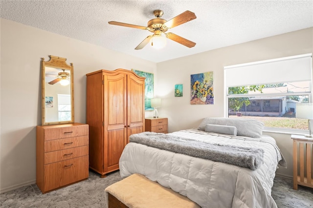 bedroom with baseboards, a ceiling fan, a textured ceiling, and light colored carpet