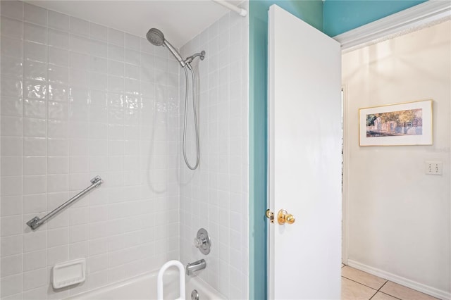 bathroom with bathtub / shower combination, tile patterned flooring, and baseboards