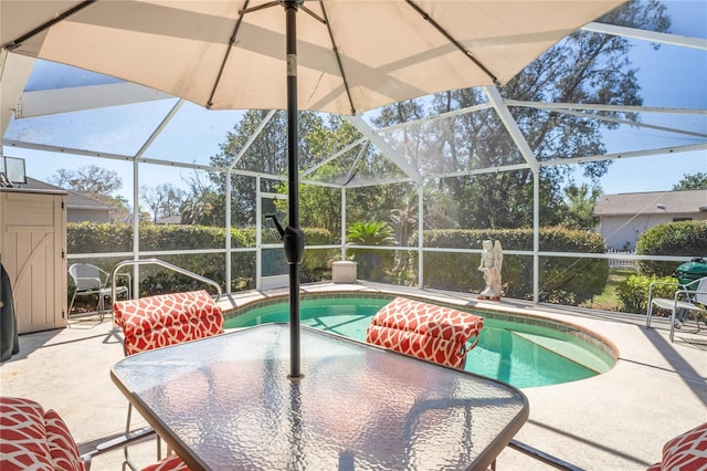 pool featuring a patio area, glass enclosure, and outdoor dining space