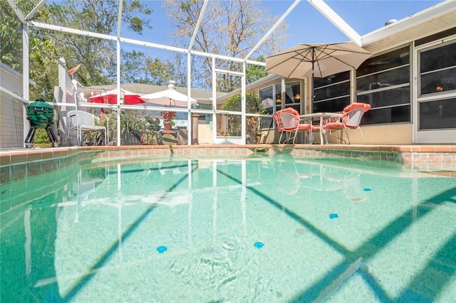 pool featuring a patio area and glass enclosure