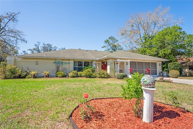 ranch-style home featuring an attached garage, driveway, and a front yard