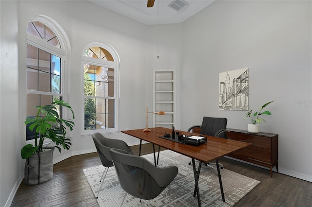 home office featuring visible vents, baseboards, ceiling fan, and dark wood-style flooring