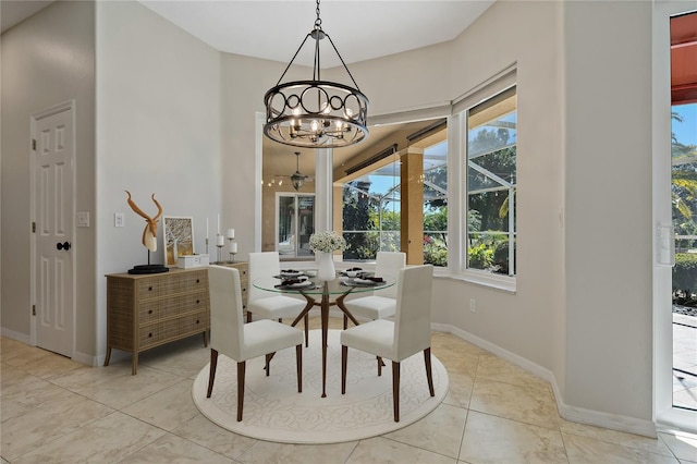 dining room with light tile patterned floors, baseboards, and a chandelier