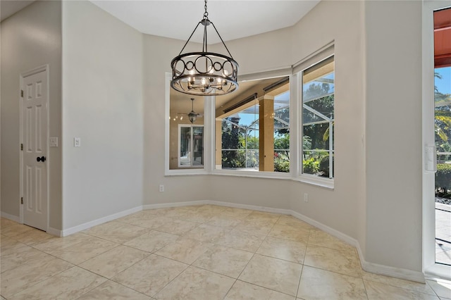unfurnished dining area featuring tile patterned floors, baseboards, and a chandelier