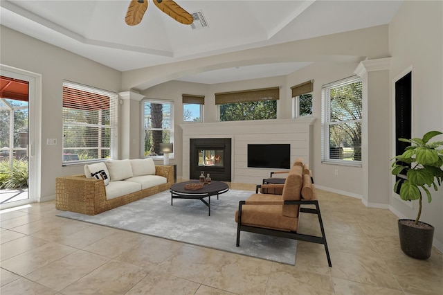 sunroom / solarium with a glass covered fireplace, visible vents, a wealth of natural light, and ceiling fan