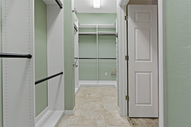 spacious closet with tile patterned flooring