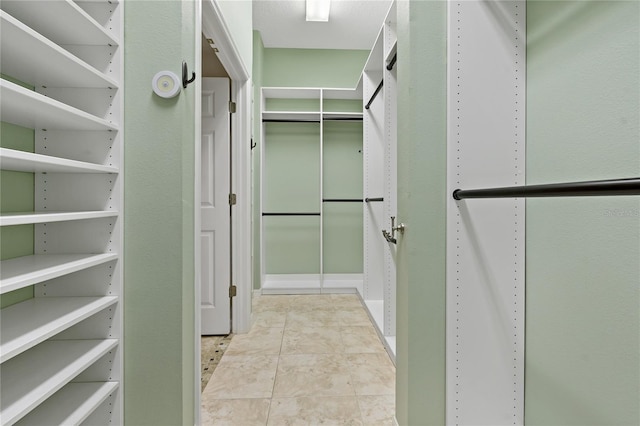 spacious closet with tile patterned flooring