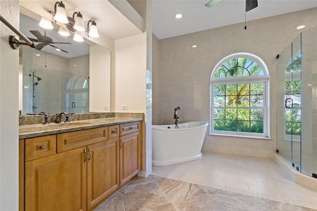full bathroom featuring a freestanding tub, vanity, ceiling fan, and a shower stall
