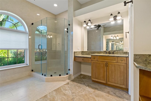 full bath featuring a wealth of natural light, vanity, ceiling fan, and a shower stall