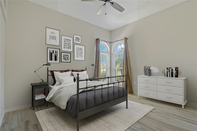 bedroom featuring a ceiling fan, baseboards, and light wood-type flooring