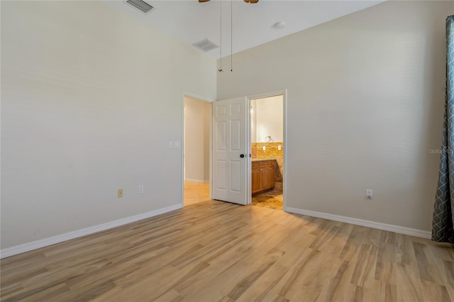 unfurnished bedroom featuring baseboards, visible vents, and light wood finished floors