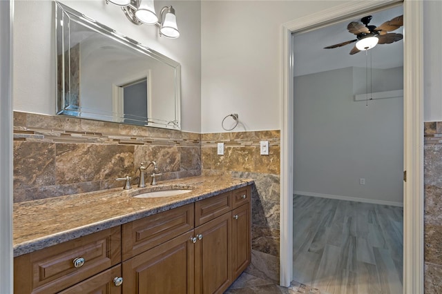 bathroom with vanity, tile walls, and a ceiling fan