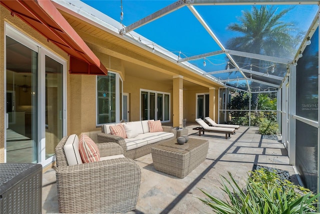view of patio / terrace featuring glass enclosure and an outdoor hangout area