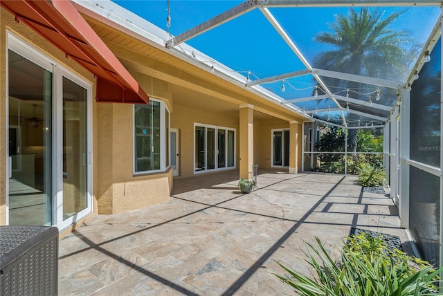 view of patio / terrace featuring glass enclosure