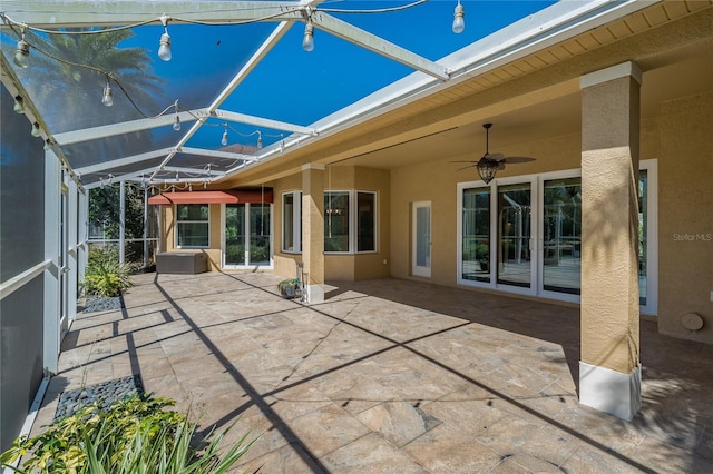 view of patio / terrace with glass enclosure and a ceiling fan