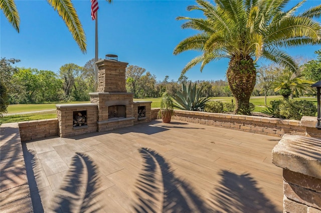 view of patio / terrace featuring an outdoor stone fireplace