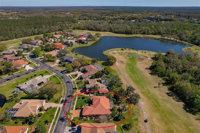 aerial view with a residential view, a wooded view, and a water view