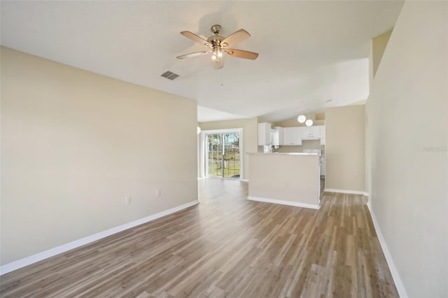 unfurnished living room with light wood-style floors, baseboards, and visible vents