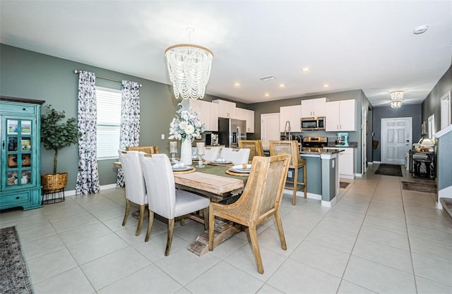 dining area featuring light tile patterned floors, recessed lighting, visible vents, baseboards, and an inviting chandelier