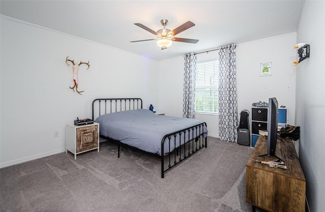 carpeted bedroom with ceiling fan and baseboards