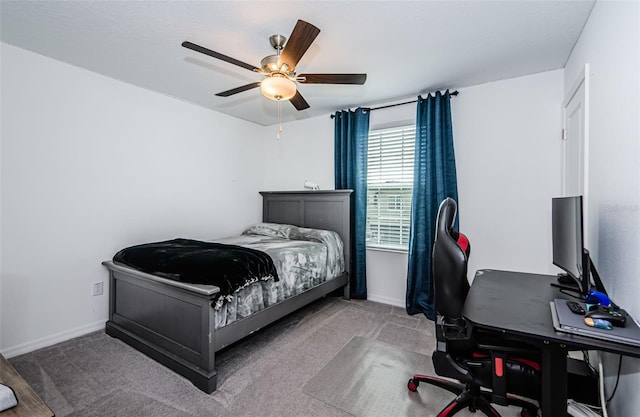 carpeted bedroom featuring ceiling fan and baseboards