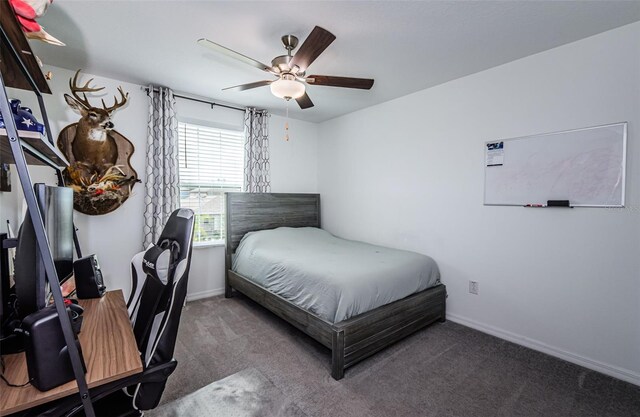 bedroom with a ceiling fan, carpet, and baseboards