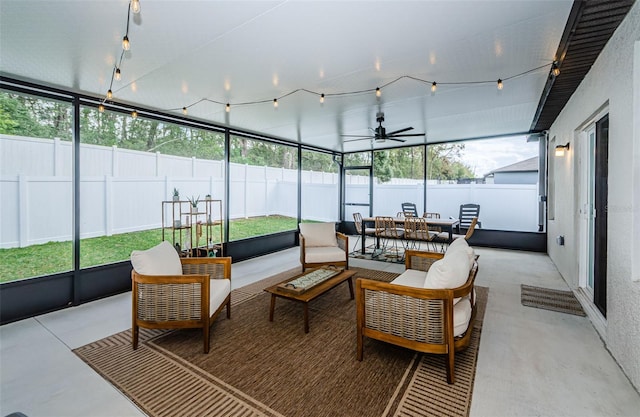 sunroom / solarium featuring ceiling fan