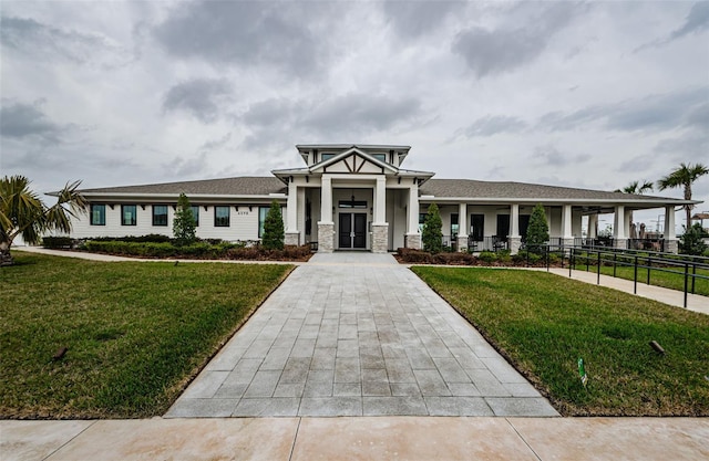 view of front of property with fence and a front lawn