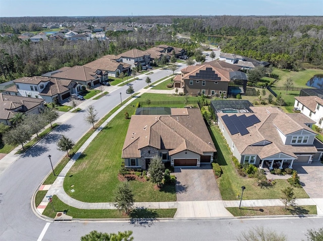 aerial view featuring a wooded view and a residential view