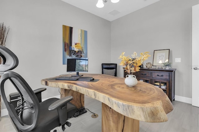 home office with visible vents and baseboards