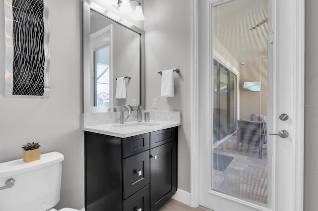 bathroom with a shower, vanity, and toilet