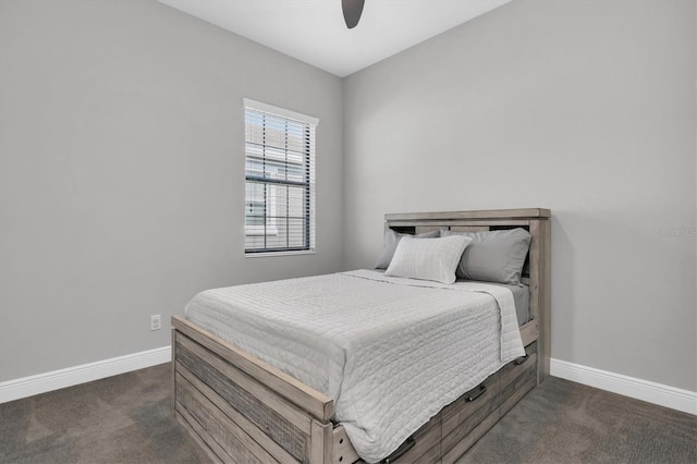 bedroom featuring baseboards, dark carpet, and a ceiling fan