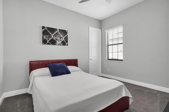 carpeted bedroom featuring baseboards and a ceiling fan