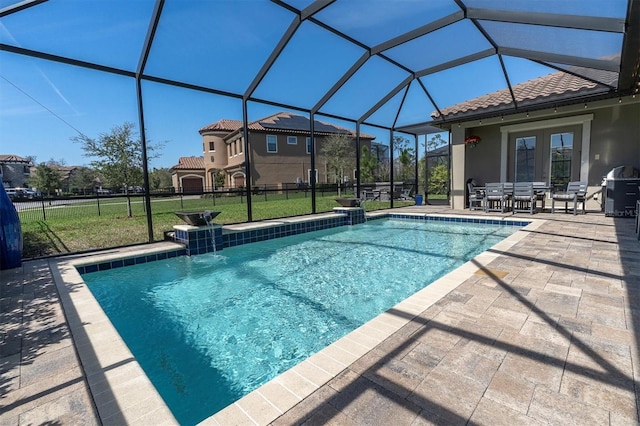 outdoor pool featuring a lanai, a patio area, and a yard