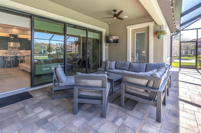 view of patio / terrace featuring ceiling fan, outdoor lounge area, and a lanai