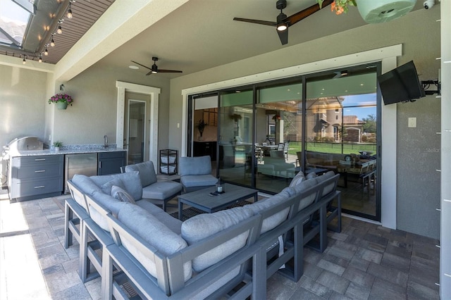 view of patio / terrace featuring ceiling fan, an outdoor kitchen, and an outdoor hangout area