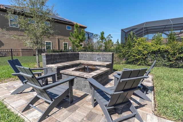 view of patio / terrace with glass enclosure, fence, and a fire pit