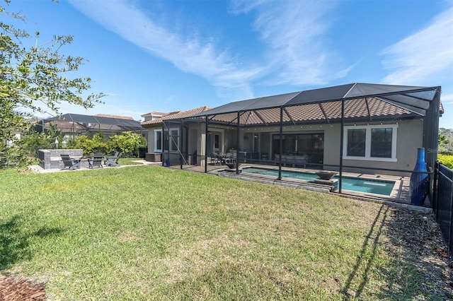 back of house featuring a yard, a tiled roof, stucco siding, an outdoor pool, and a patio area