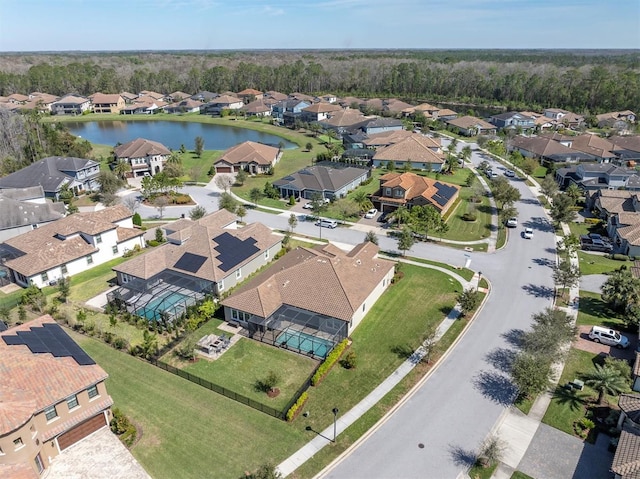 drone / aerial view with a water view and a residential view