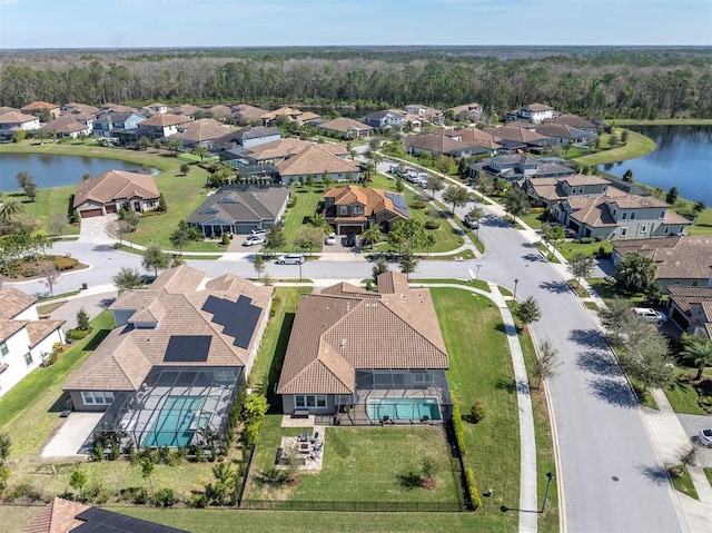 drone / aerial view featuring a residential view and a water view