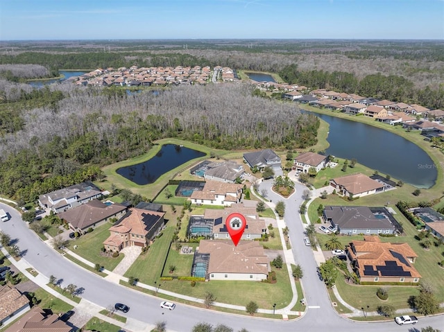 birds eye view of property with a residential view and a water view