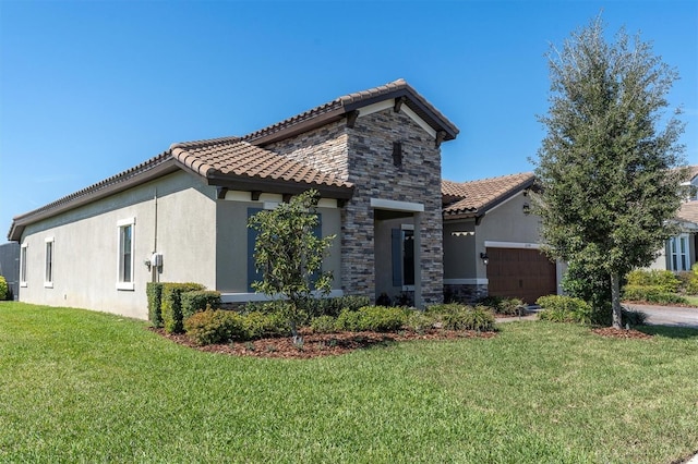 mediterranean / spanish-style house with stone siding, an attached garage, and stucco siding