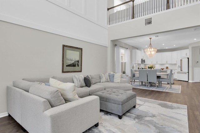 living room with visible vents, a chandelier, wood finished floors, and recessed lighting