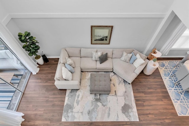 living area with baseboards and wood finished floors